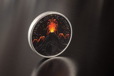 Description This wonderful 2 Oz Silver coin is the first release in the “Magical Creatures At Night” series and is dedicated to the blazing figure of the Phoenix, represented as a light source in the darkness, born from a vulcanic eruption! The coin features the Smartminting technology, has Proof quality and comes in a case, along with the Certificate of Authenticity. Limited mintage to 499 pcs worldwide. Design The reverse of the coin shows an extraordinary depiction of the Phoenix, a mythological creature associated with fire, glowing with fiery colors in the night. It has a gaze that expresses ferocity and determination and a symmetrical pose that seems to turn to attack. The bright hues create an effective and striking visual contrast. On the obverse, the first volcano erupts to reinforce the idea of great fire energy, from which the Phoenix is born. From the other volcanos, other magical creatures will come to life! On the obverse of the coin also the Coat of Arms of Palau and the inscriptions: “REPUBLIC OF PALAU” – the issuing country, “10$” – the face value and “MAGICAL CREATURES AT NIGHT” – the name of the series.